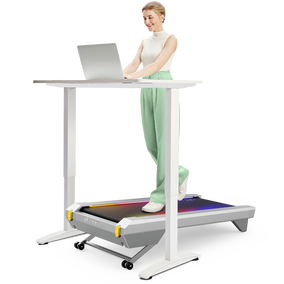 A woman uses a laptop on the UREVO CyberPad for Office Smart Treadmill, combining work with exercise.