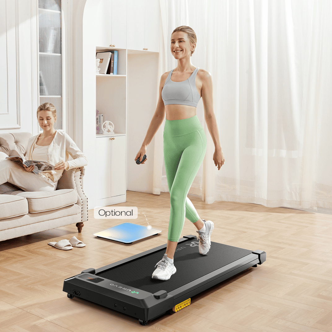 A woman walks on the UREVO SpaceWalk E1L Treadmill in a cozy living room, highlighting its compact and home-friendly design.